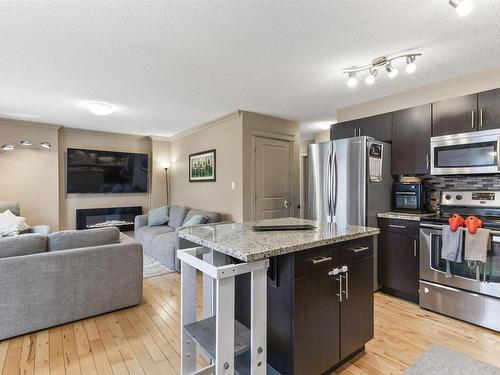 6914 19A Avenue, Edmonton, AB - Indoor Photo Showing Kitchen With Fireplace With Stainless Steel Kitchen