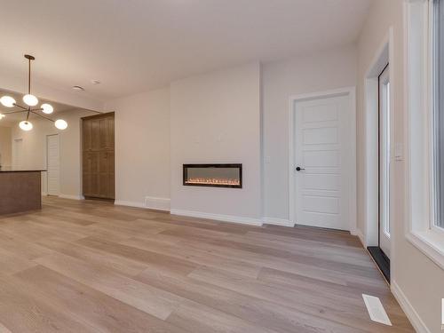 175 Stonehouse Way, Leduc, AB - Indoor Photo Showing Other Room With Fireplace