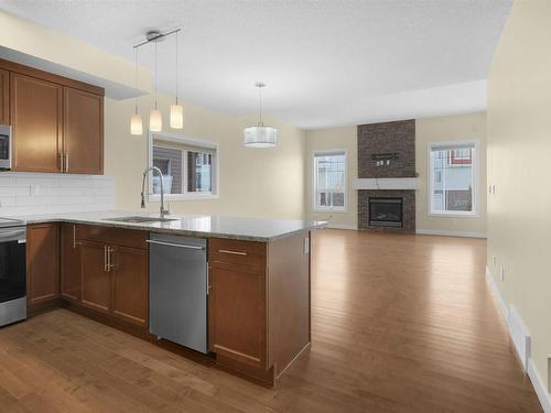 3071 Carpenter Landing, Edmonton, AB - Indoor Photo Showing Kitchen With Fireplace