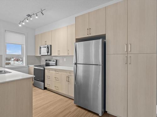 303 17 Columbia Avenue, Devon, AB - Indoor Photo Showing Kitchen With Stainless Steel Kitchen