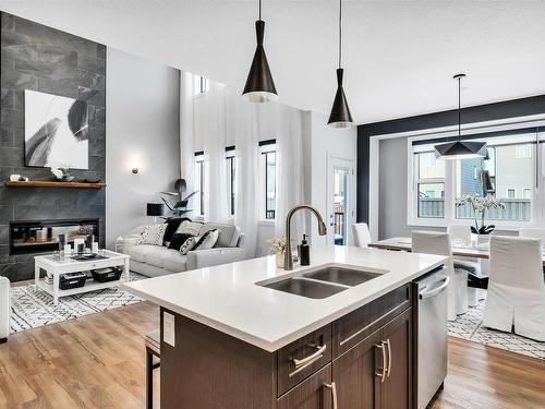 7024 Chivers Loop, Edmonton, AB - Indoor Photo Showing Kitchen With Fireplace With Double Sink