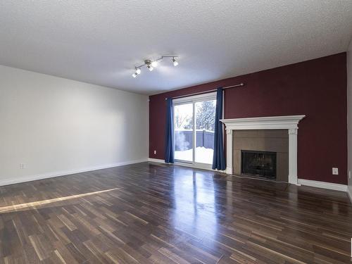 173 Tudor Lane, Edmonton, AB - Indoor Photo Showing Living Room With Fireplace