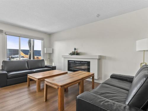 1122 33A Street, Edmonton, AB - Indoor Photo Showing Living Room With Fireplace