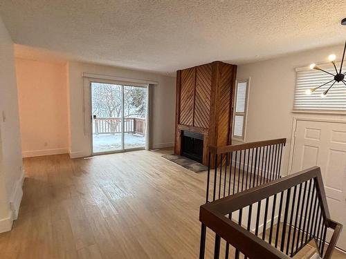 5615 92C Avenue Nw, Edmonton, AB - Indoor Photo Showing Other Room With Fireplace