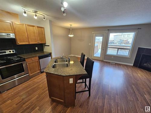 117 101 Drive, Leduc, AB - Indoor Photo Showing Kitchen With Fireplace With Double Sink