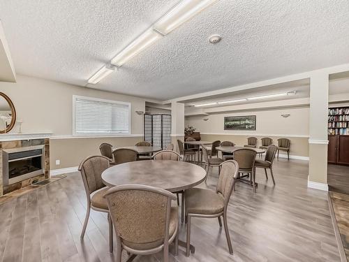 319 12111 51 Avenue, Edmonton, AB - Indoor Photo Showing Dining Room With Fireplace