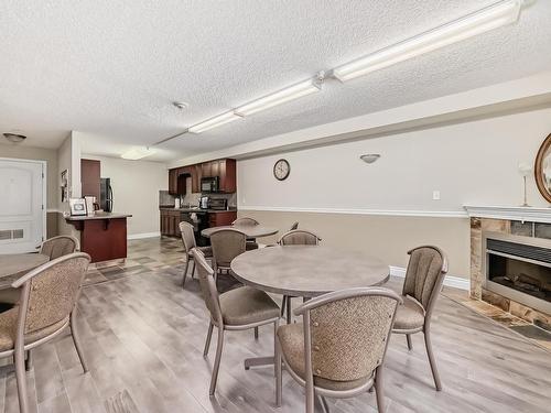 319 12111 51 Avenue, Edmonton, AB - Indoor Photo Showing Dining Room With Fireplace