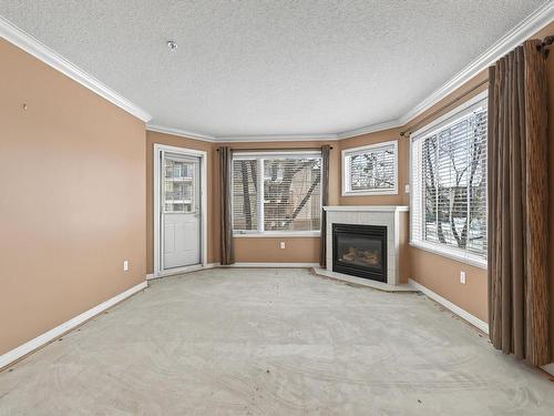 215 17150 94A Avenue, Edmonton, AB - Indoor Photo Showing Living Room With Fireplace