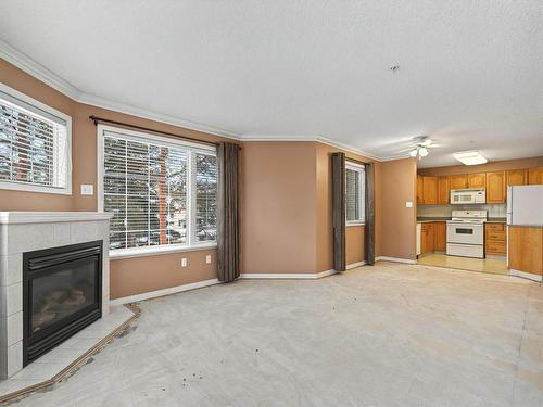 215 17150 94A Avenue, Edmonton, AB - Indoor Photo Showing Living Room With Fireplace