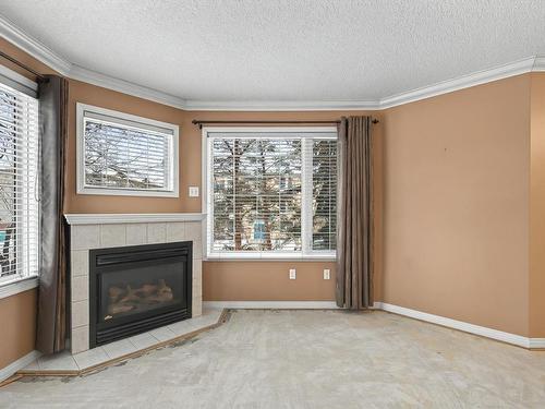 215 17150 94A Avenue, Edmonton, AB - Indoor Photo Showing Living Room With Fireplace