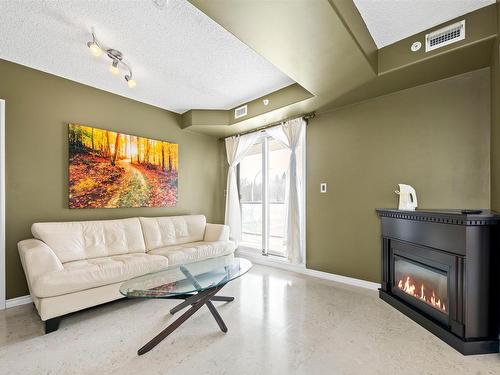 201 9707 106 Street, Edmonton, AB - Indoor Photo Showing Living Room With Fireplace