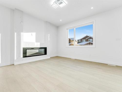 822 Northern Harrier Lane, Edmonton, AB - Indoor Photo Showing Living Room With Fireplace