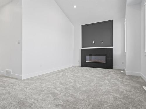 4743 Alwood Bend Bend, Edmonton, AB - Indoor Photo Showing Other Room With Fireplace