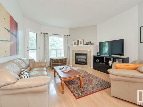 104 10719 80 Avenue Nw, Edmonton, AB - Indoor Photo Showing Living Room With Fireplace