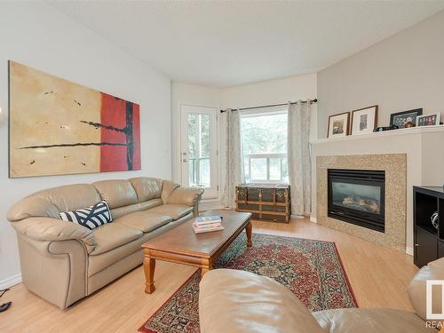 104 10719 80 Avenue Nw, Edmonton, AB - Indoor Photo Showing Living Room With Fireplace