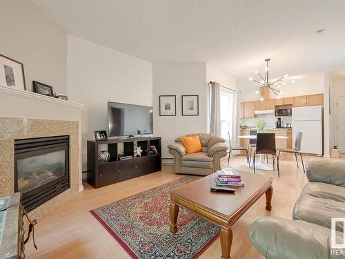 104 10719 80 Avenue Nw, Edmonton, AB - Indoor Photo Showing Living Room With Fireplace