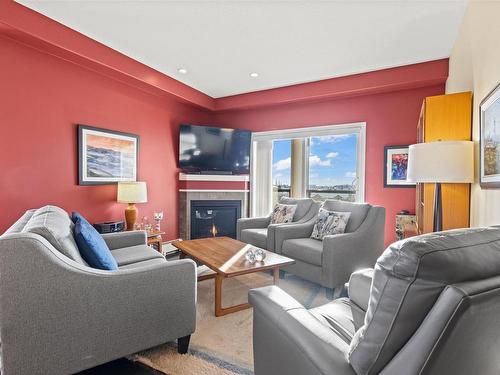 467 11517 Ellerslie Road, Edmonton, AB - Indoor Photo Showing Living Room With Fireplace