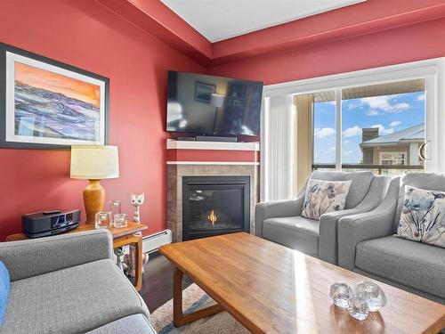 467 11517 Ellerslie Road, Edmonton, AB - Indoor Photo Showing Living Room With Fireplace