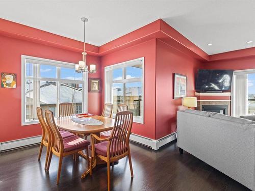 467 11517 Ellerslie Road, Edmonton, AB - Indoor Photo Showing Dining Room With Fireplace