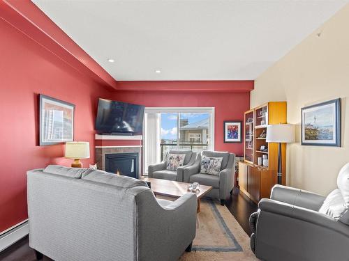 467 11517 Ellerslie Road, Edmonton, AB - Indoor Photo Showing Living Room With Fireplace