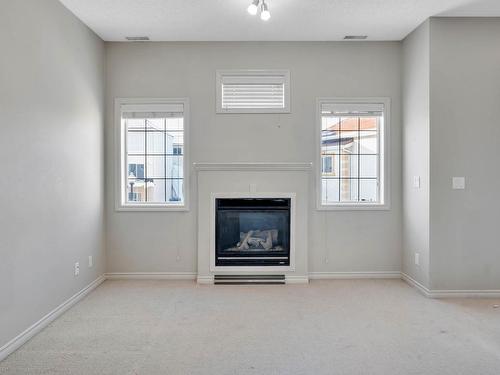 Edmonton, AB - Indoor Photo Showing Living Room With Fireplace