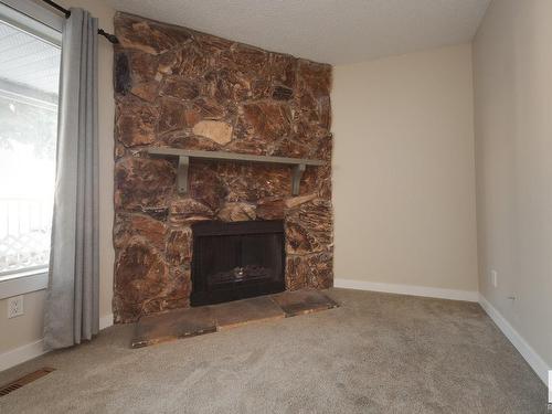 220 10404 24 Avenue, Edmonton, AB - Indoor Photo Showing Living Room With Fireplace