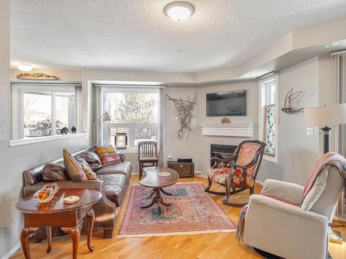 103 7951 96 Street, Edmonton, AB - Indoor Photo Showing Living Room With Fireplace