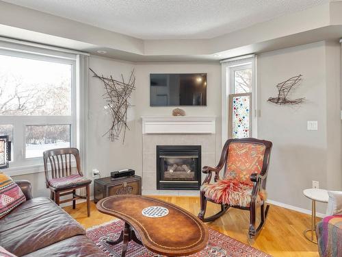 103 7951 96 Street, Edmonton, AB - Indoor Photo Showing Living Room With Fireplace