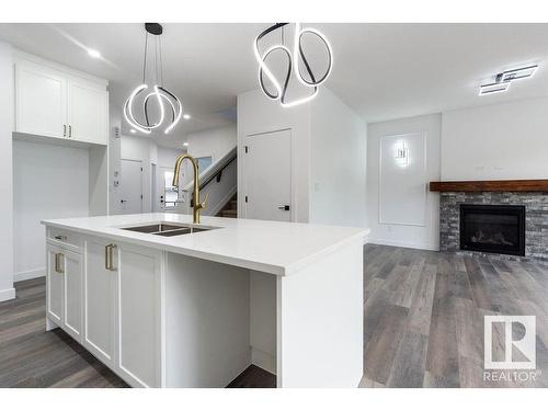 6630 Crawford Landing Landing, Edmonton, AB - Indoor Photo Showing Kitchen With Fireplace With Double Sink