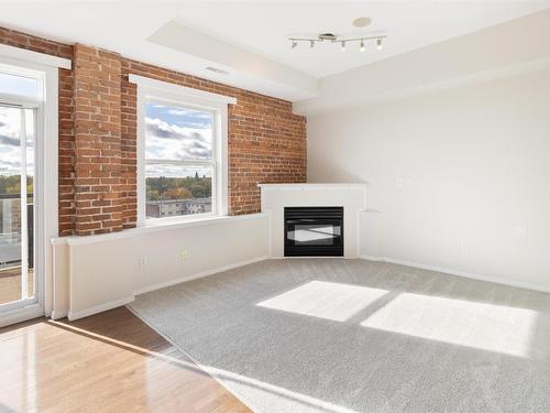 511 10728 82 Avenue, Edmonton, AB - Indoor Photo Showing Other Room With Fireplace