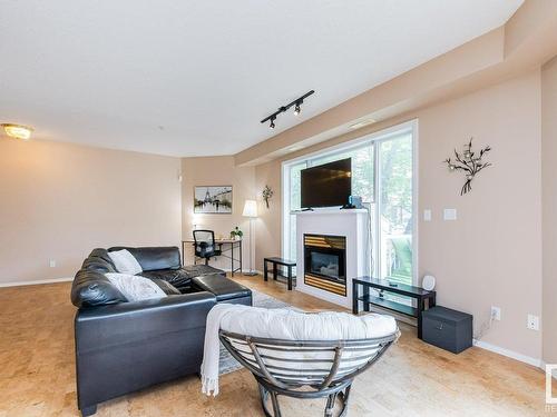 106 10933 82 Avenue, Edmonton, AB - Indoor Photo Showing Living Room With Fireplace