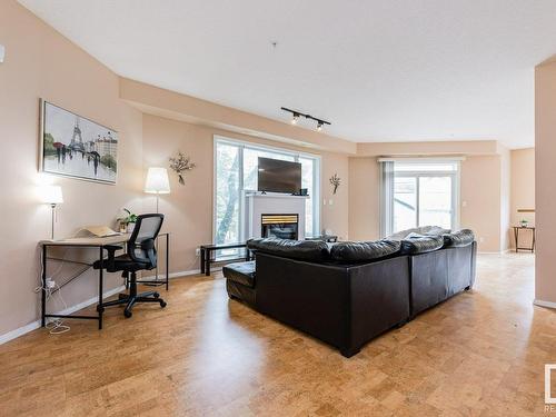 106 10933 82 Avenue, Edmonton, AB - Indoor Photo Showing Living Room With Fireplace