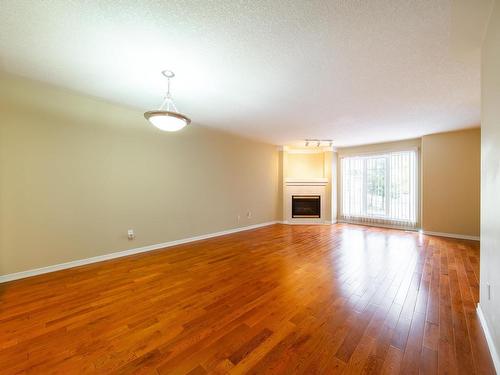 21 2419 133 Avenue, Edmonton, AB - Indoor Photo Showing Living Room With Fireplace