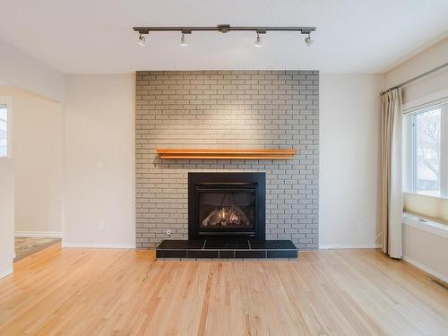 Edmonton, AB - Indoor Photo Showing Living Room With Fireplace