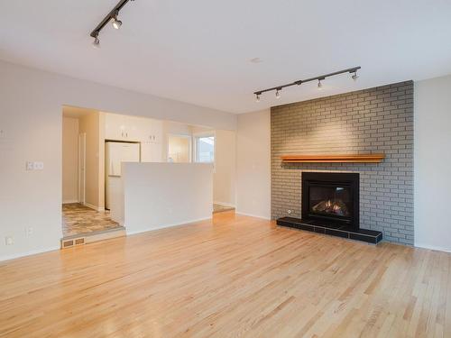 Edmonton, AB - Indoor Photo Showing Living Room With Fireplace