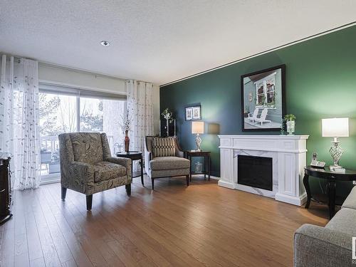 306 10915 21 Avenue, Edmonton, AB - Indoor Photo Showing Living Room With Fireplace