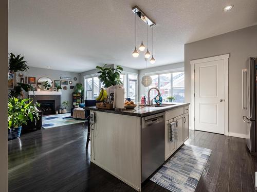 8611 Summerside Grande Boulevard, Edmonton, AB - Indoor Photo Showing Kitchen With Fireplace