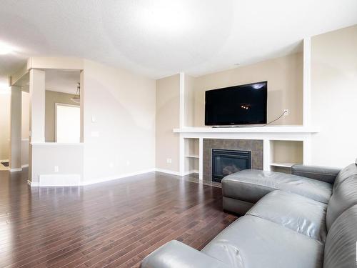 5932 12 Avenue, Edmonton, AB - Indoor Photo Showing Living Room With Fireplace