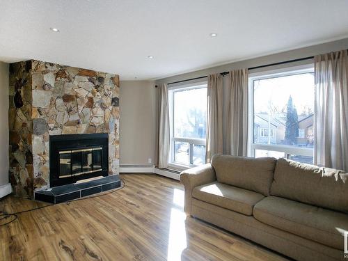 106 9854 88 Avenue, Edmonton, AB - Indoor Photo Showing Living Room With Fireplace