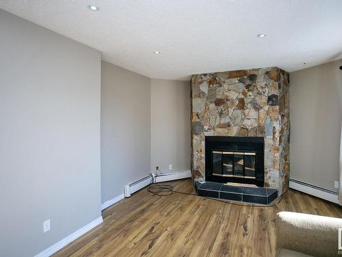 106 9854 88 Avenue, Edmonton, AB - Indoor Photo Showing Living Room With Fireplace