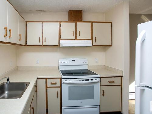 106 9854 88 Avenue, Edmonton, AB - Indoor Photo Showing Kitchen With Double Sink