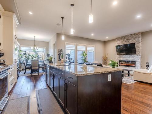 3036 58 Avenue Ne, Rural Leduc County, AB - Indoor Photo Showing Kitchen With Fireplace With Upgraded Kitchen