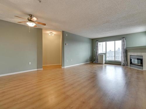 414 11716 100 Avenue, Edmonton, AB - Indoor Photo Showing Living Room With Fireplace