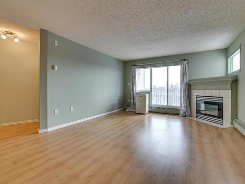 414 11716 100 Avenue, Edmonton, AB - Indoor Photo Showing Living Room With Fireplace