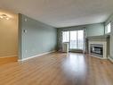 414 11716 100 Avenue, Edmonton, AB  - Indoor Photo Showing Living Room With Fireplace 