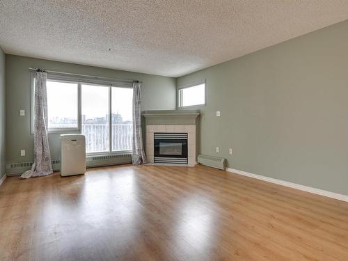 414 11716 100 Avenue, Edmonton, AB - Indoor Photo Showing Living Room With Fireplace