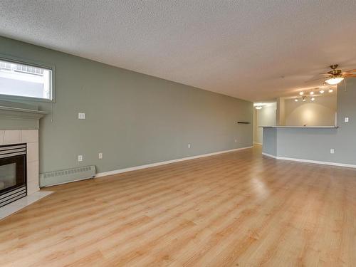 414 11716 100 Avenue, Edmonton, AB - Indoor Photo Showing Living Room With Fireplace