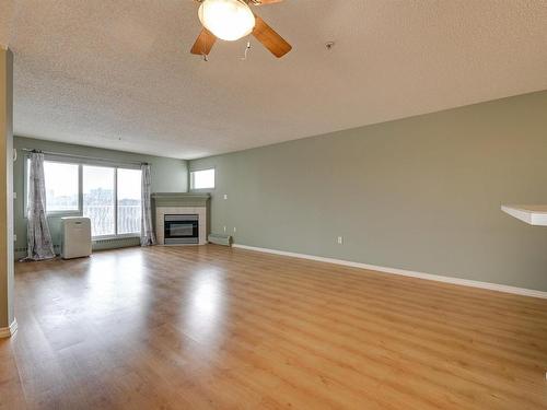 414 11716 100 Avenue, Edmonton, AB - Indoor Photo Showing Living Room With Fireplace