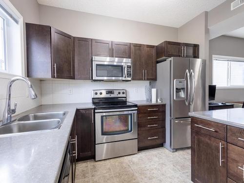 17 6520 2 Avenue Sw, Edmonton, AB - Indoor Photo Showing Kitchen With Double Sink