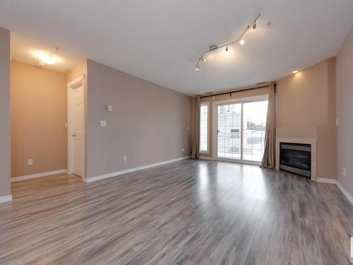 202 12110 106 Avenue, Edmonton, AB - Indoor Photo Showing Living Room With Fireplace